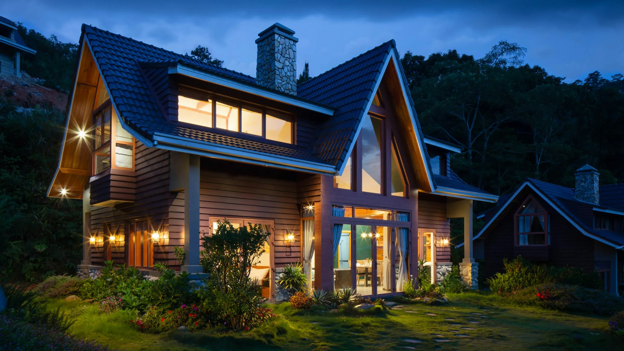 Wooden chalet with warm lights at dusk