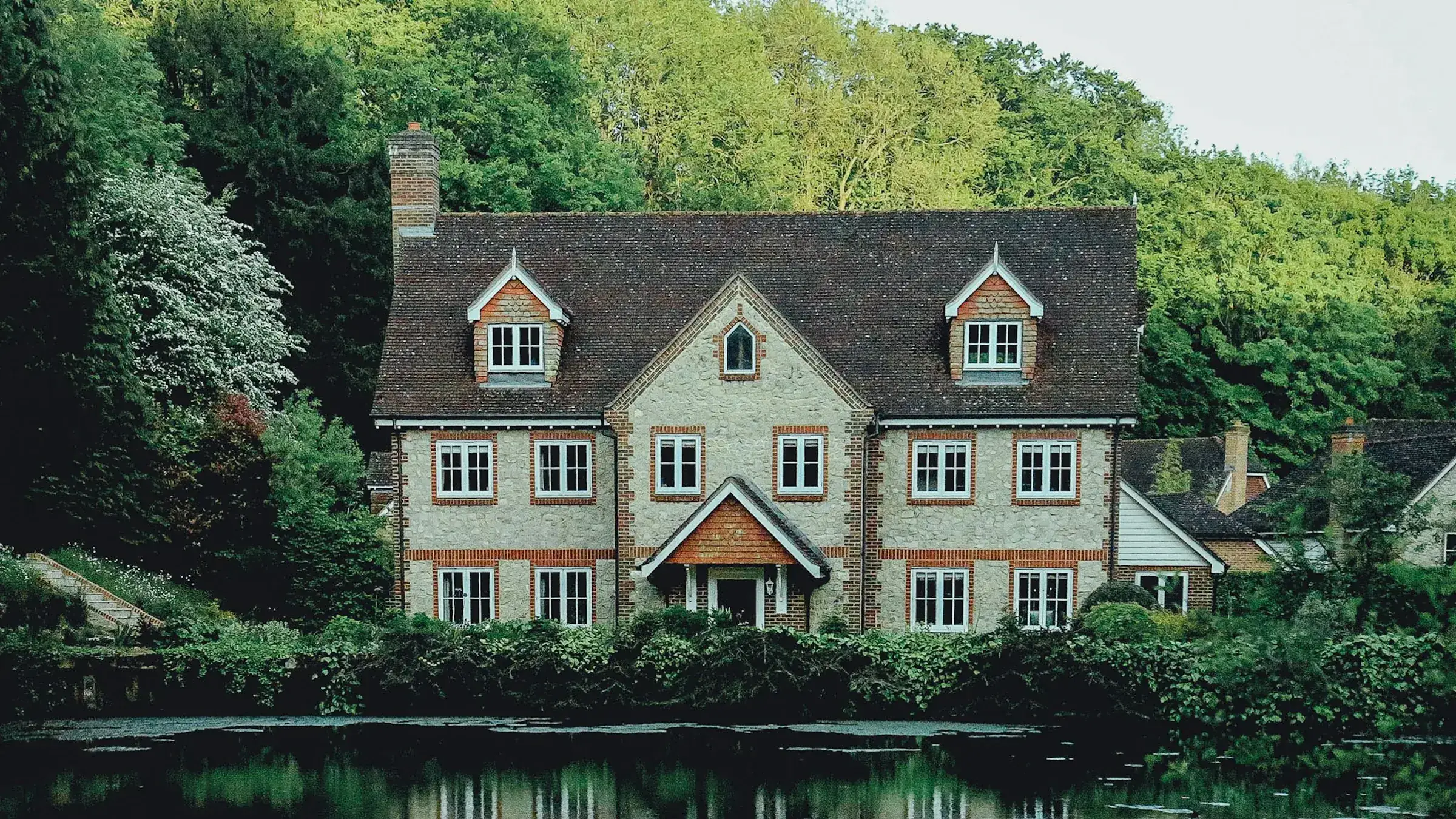 Country house by a pond among trees